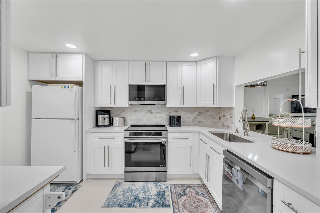 3920 Inverrary Boulevard, Unit 104C Lauderhill, FL 33319 - Photo 3 of 15 a kitchen with cabinets stainless steel appliances and sink