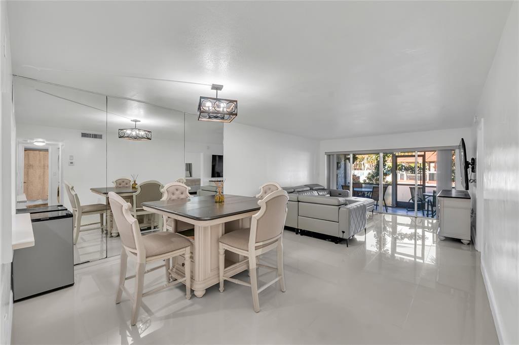 3920 Inverrary Boulevard, Unit 104C Lauderhill, FL 33319 - Photo 4 of 15 a dining room with furniture and a large window
