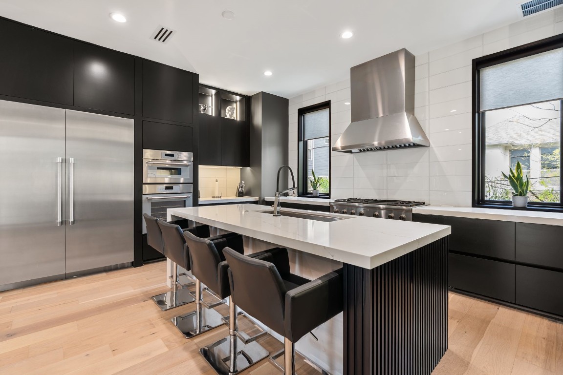 1918 Brun Street Houston, TX 77019 - Photo 13 of 43 High end stainless steel appliances, built in double ovens, a gas cooktop with vent hood, and other thoughtful details enhance the space and truly make it feel luxurious.
