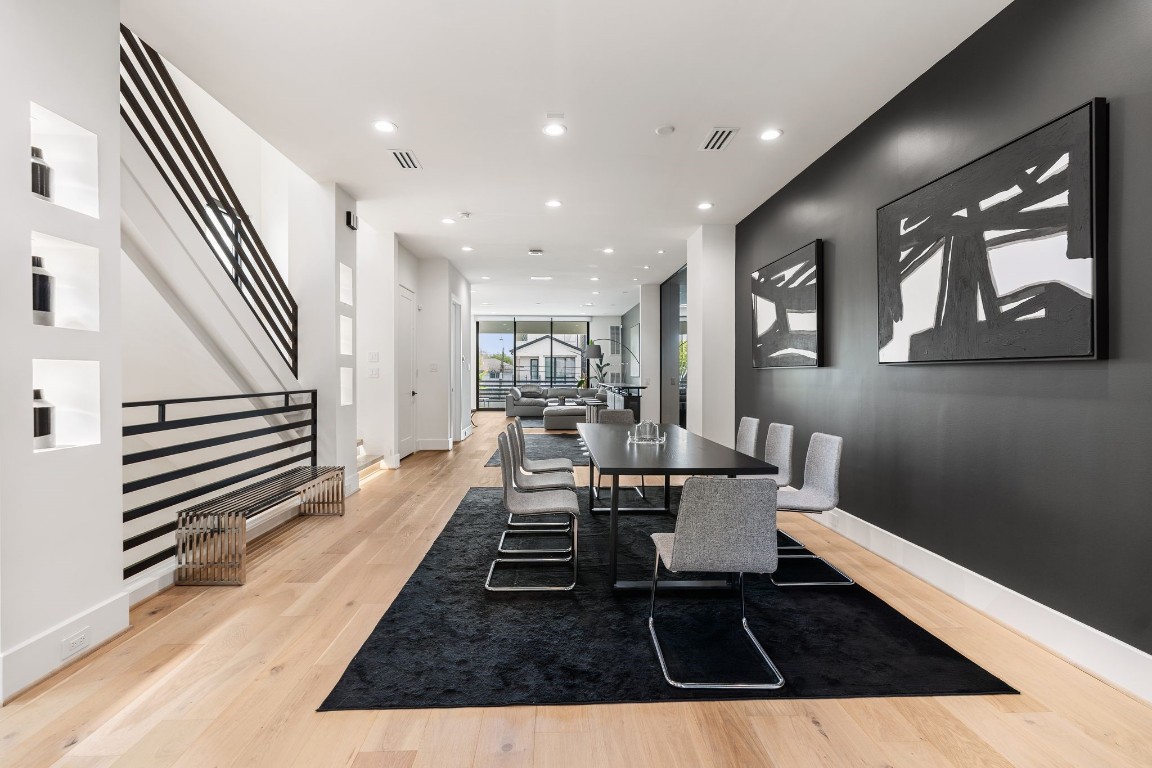 1918 Brun Street Houston, TX 77019 - Photo 18 of 43 Wide plank wood flooring and the open concept layout create a seamless connection to the surrounding living spaces. Take note of the art niches that add dimension to the space.