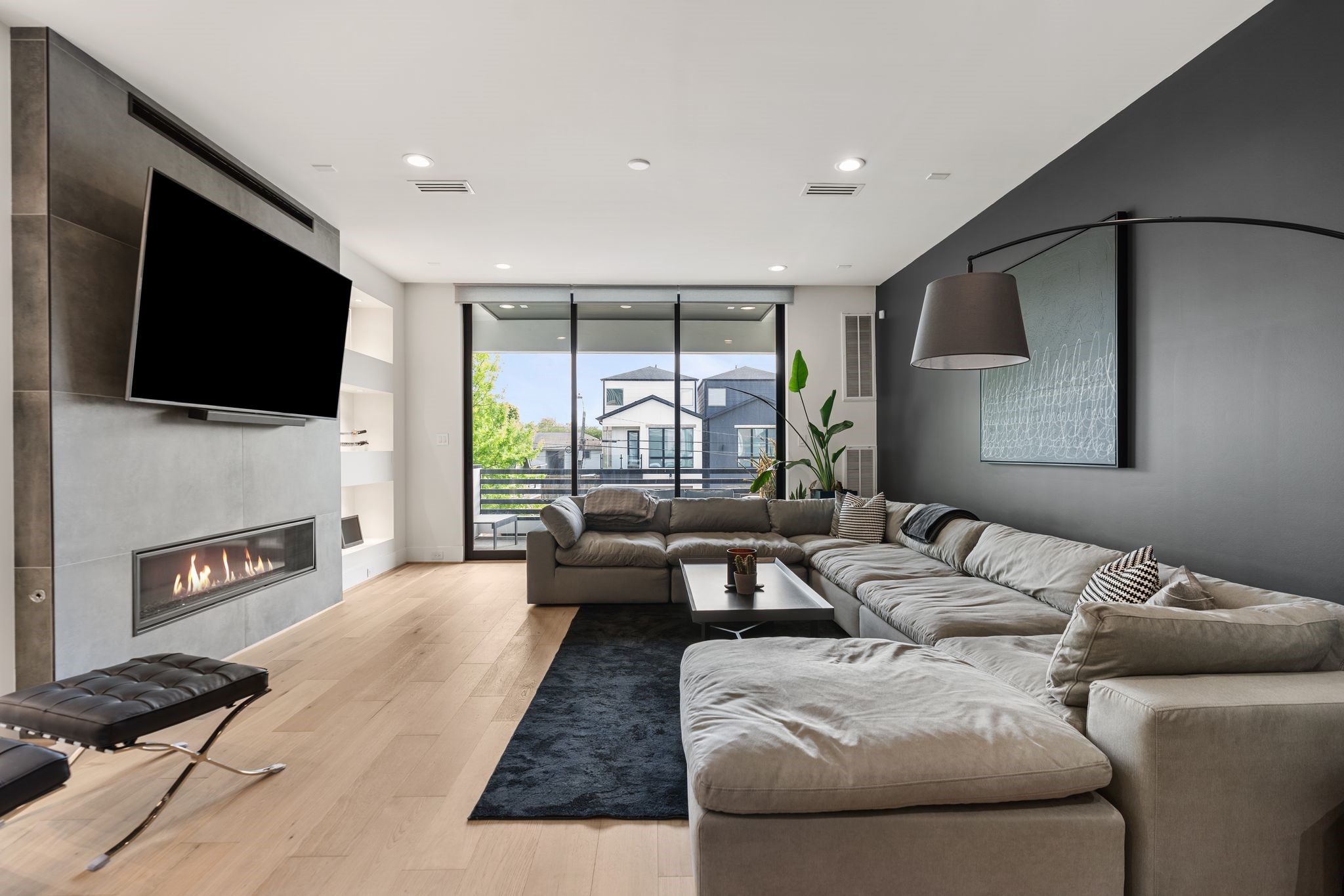 1918 Brun Street Houston, TX 77019 - Photo 23 of 43 Welcome to your gorgeous living area. Expansive sliding glass doors fill the space with natural light and provide access to the balcony that overlooks Houston's skyline!