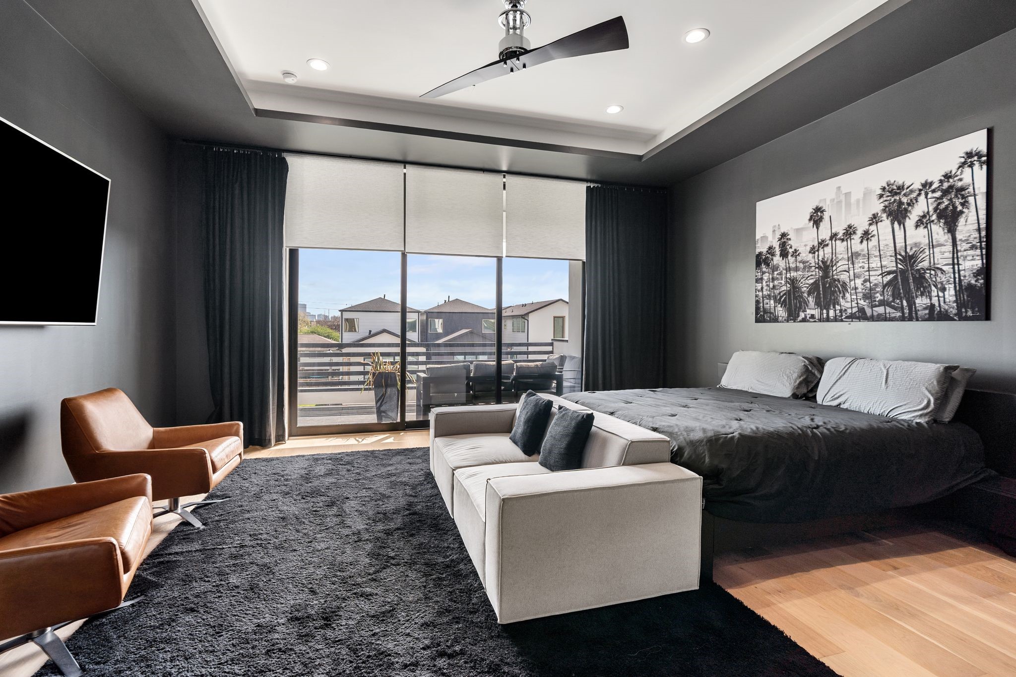 1918 Brun Street Houston, TX 77019 - Photo 29 of 43 Spacious and sophisticated, the primary suite offers a relaxing retreat with modern design elements throughout. Automatic shades provide added convenience and privacy, while large windows allow natural light to fill the room.
