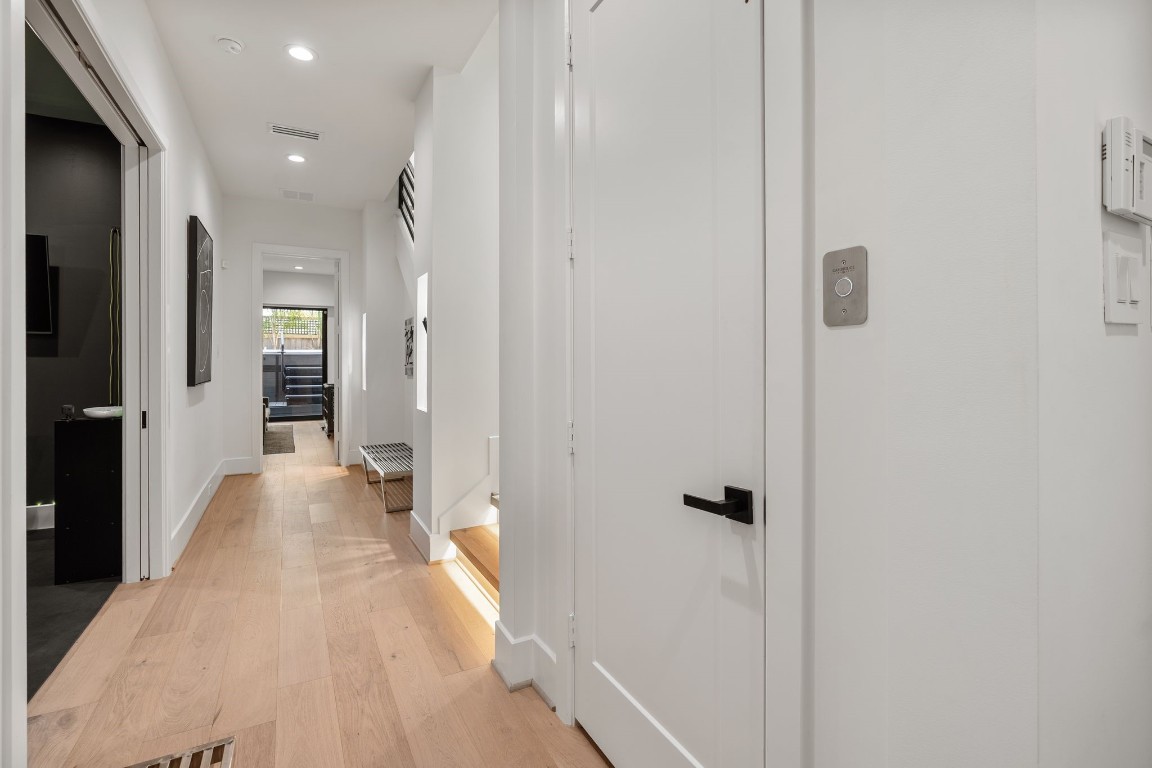1918 Brun Street Houston, TX 77019 - Photo 3 of 43 A bright and inviting entry welcomes you with wide plank wood flooring, modern recessed lighting, and a clean contemporary design. This thoughtfully planned space offers a seamless flow toward the first level bedroom, backyard with a spa, and your versatile office/bonus room.