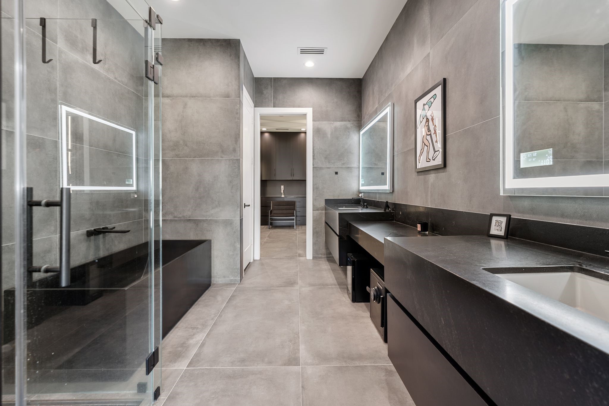 1918 Brun Street Houston, TX 77019 - Photo 34 of 43 Wow! Take in your breathtaking spa inspired primary bathroom that showcases a sleek double vanity with modern sinks, designer framed mirrors, and extensive countertop space.