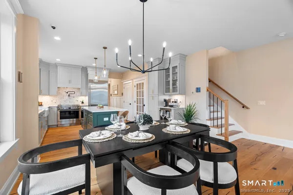a view of a dining room with furniture wooden floor and chandelier