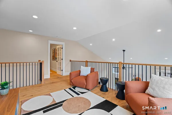 a living room with furniture and a wooden floor