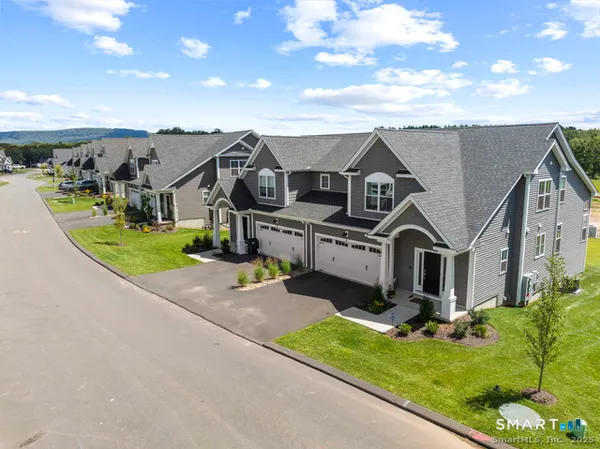 an aerial view of a house with a yard