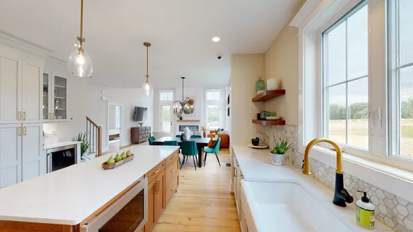 a large kitchen with a large counter top appliances and cabinets