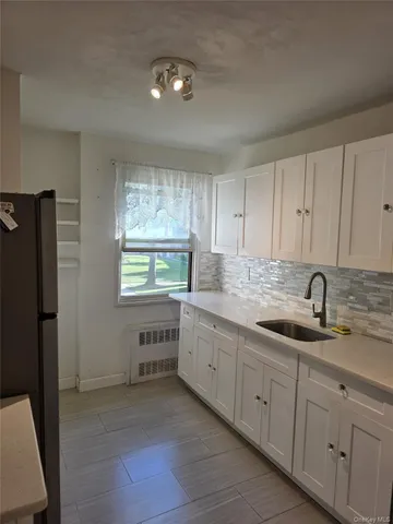 a kitchen with sink cabinets and window