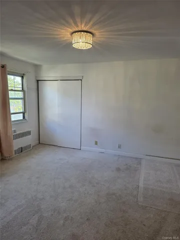an empty room with a empty space and windows
