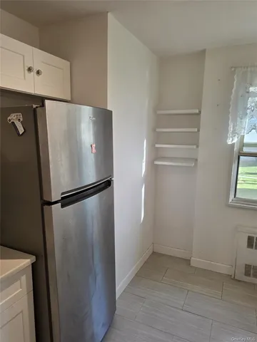a white refrigerator freezer sitting in a kitchen