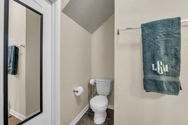 a white toilet sitting next to a bathroom sink