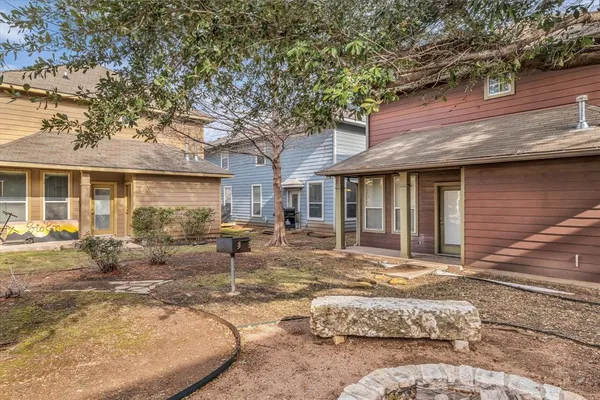 a view of a house with backyard porch and sitting area