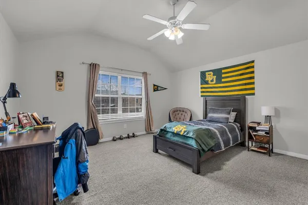a spacious bedroom with a bed and a window
