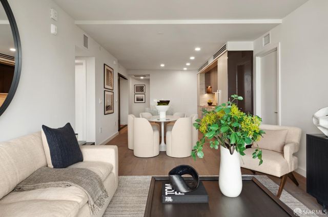 a living room with furniture and a potted plant