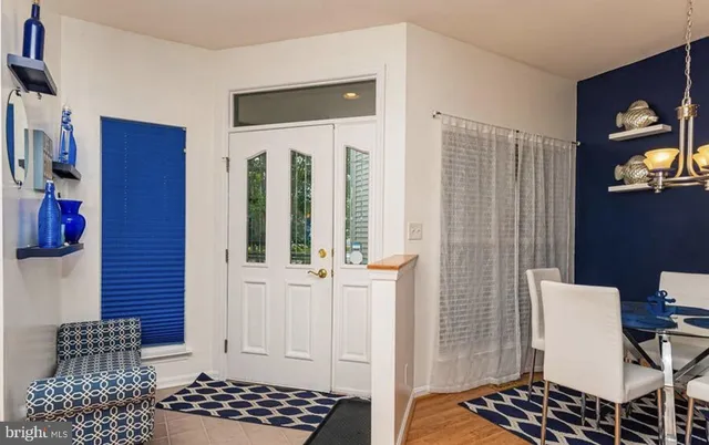 a bedroom with a chair and wooden floor