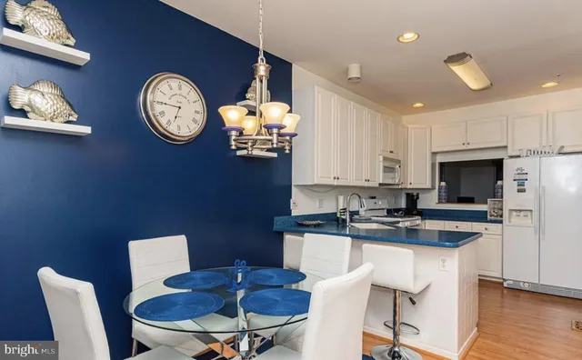 a kitchen with a dining table and chairs