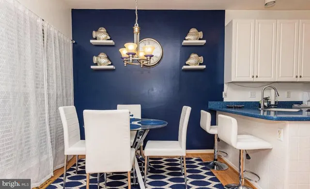a view of a dining room with furniture and chandelier