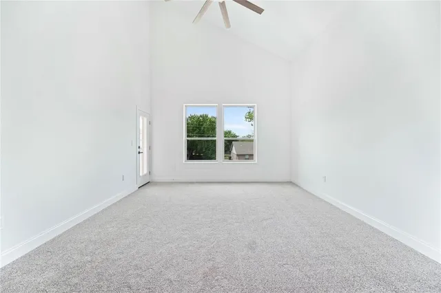a view of a livingroom with a ceiling fan and window