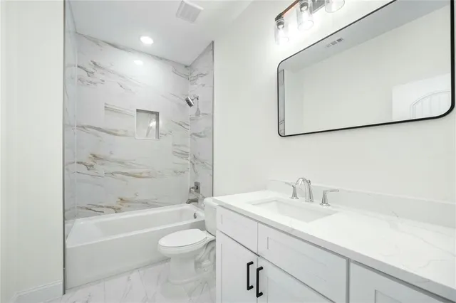 a kitchen with a white cabinets and wooden floor