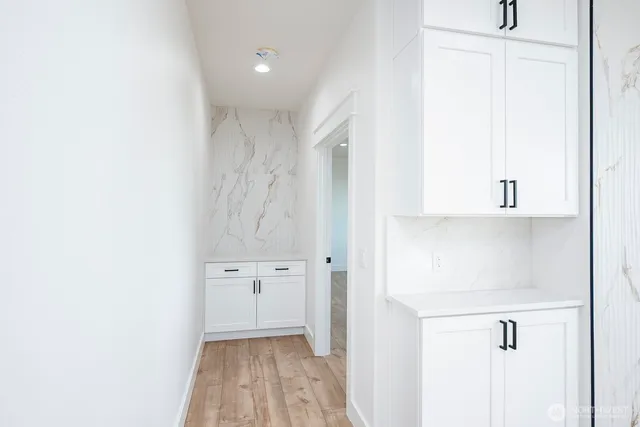 a view of walk in closet with white walls