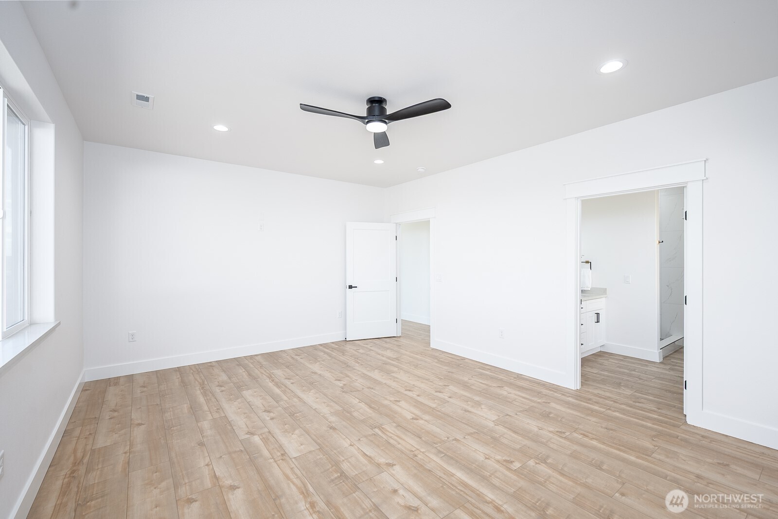 2394 Hunters Street Ephrata, WA 98823 - Photo 12 of 29 an empty room with wooden floor and windows