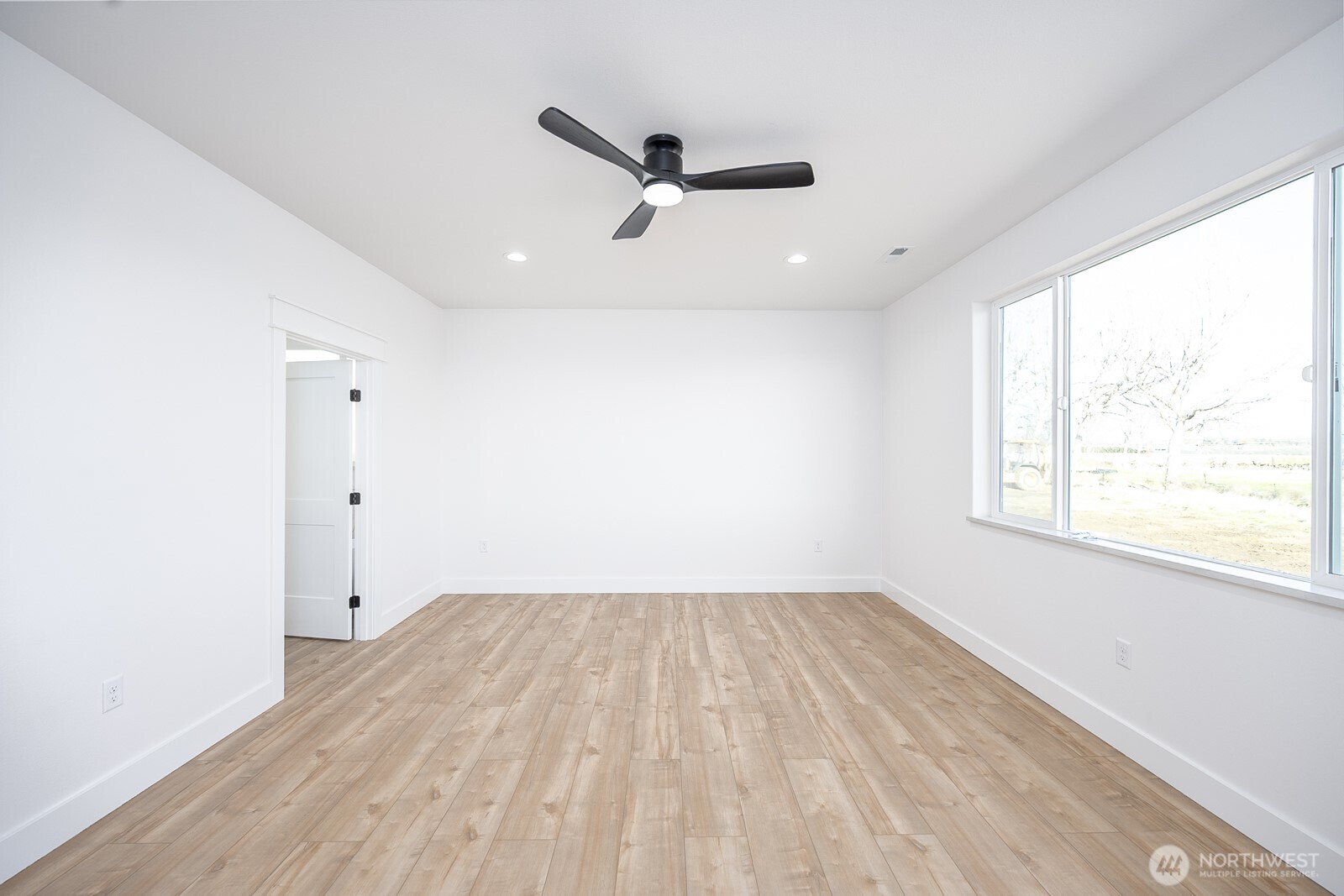 2394 Hunters Street Ephrata, WA 98823 - Photo 13 of 29 a view of empty room with wooden floor and fan