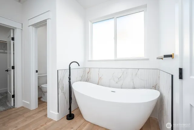 a white bath tub sitting next to a window