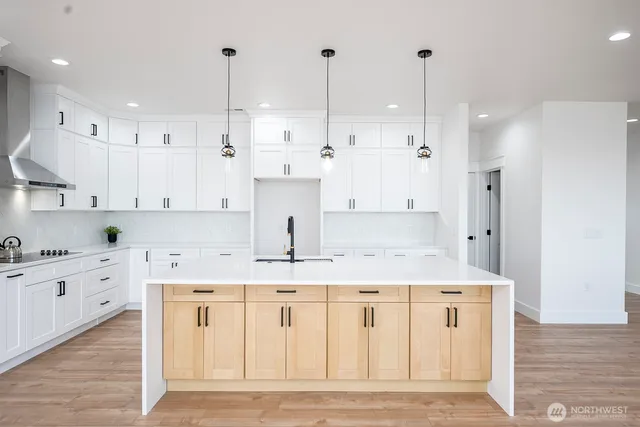 a kitchen with a refrigerator a sink and cabinets