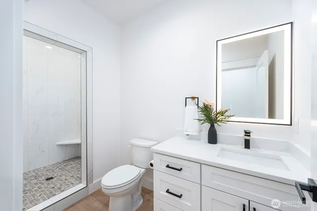 a bathroom with a sink a toilet and a mirror