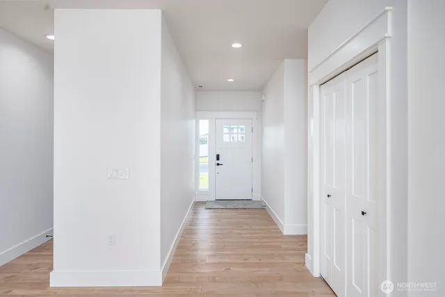 a view of a hallway with wooden floor