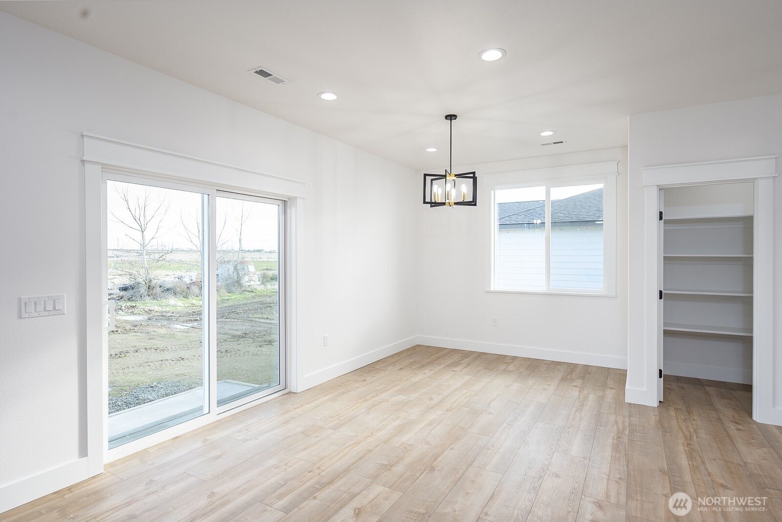 2394 Hunters Street Ephrata, WA 98823 - Photo 8 of 29 a view of an empty room with a window and wooden floor