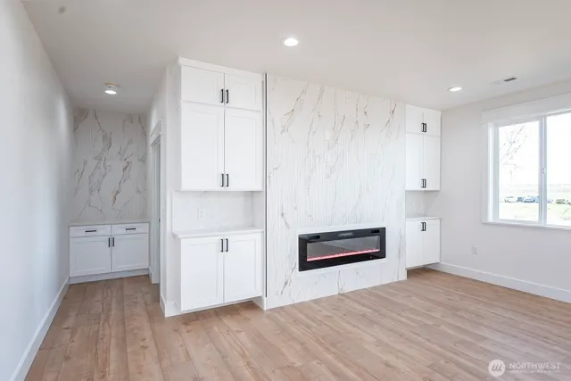 a view of kitchen with granite countertop cabinets and wooden floor