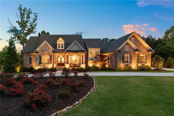 a front view of a house with a garden