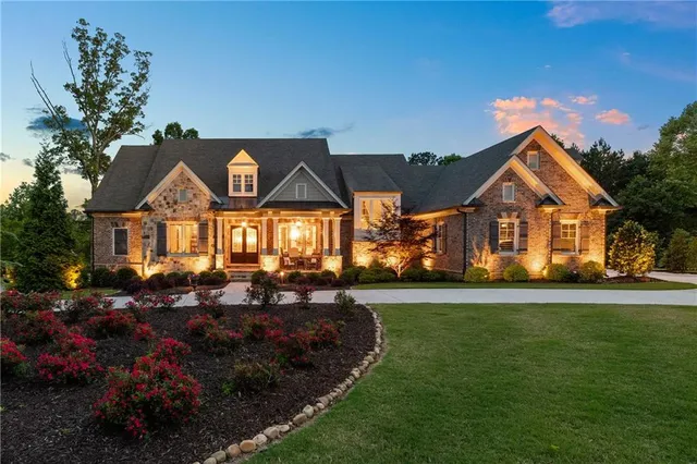a front view of a house with a garden