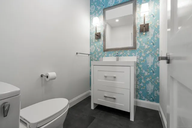 a view of a livingroom with wooden floor a fireplace and a window
