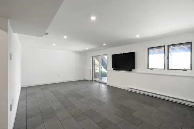 an empty room with a empty space and windows