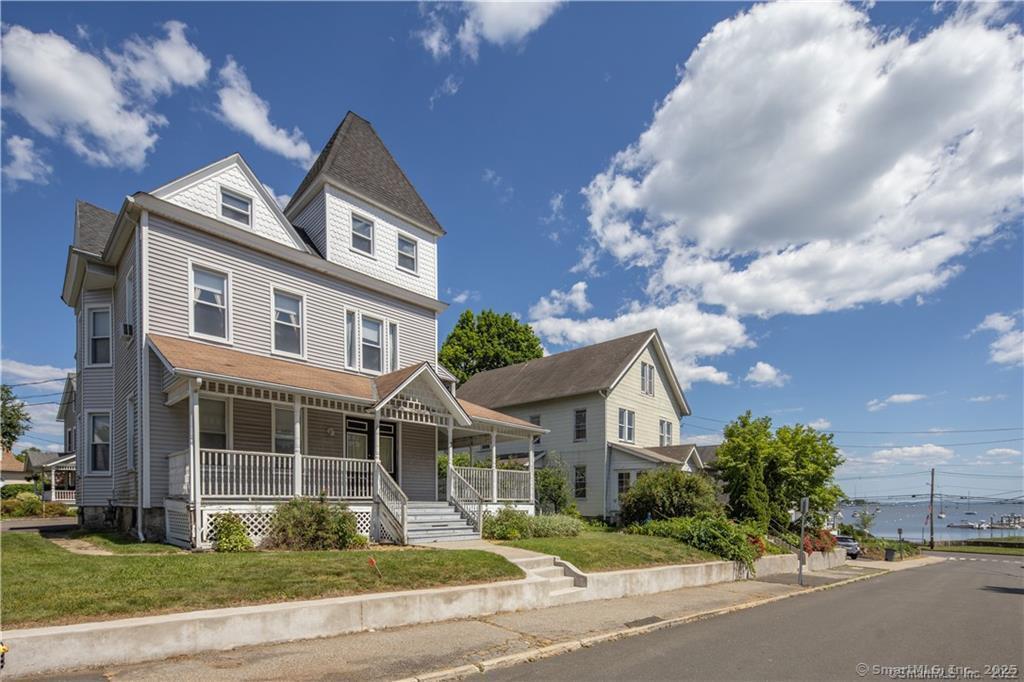 3 Betts Place, Unit 4 Norwalk, CT 06855 - Photo 1 of 1 a front view of a house with a yard