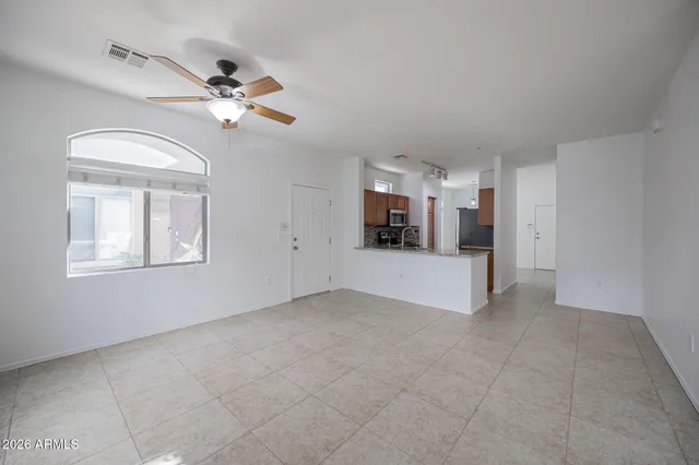 a view of a livingroom with a ceiling fan and window