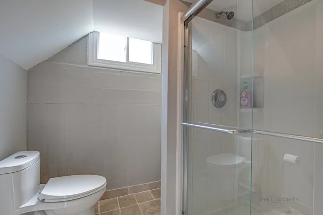 a white toilet sitting next to a bathroom sink