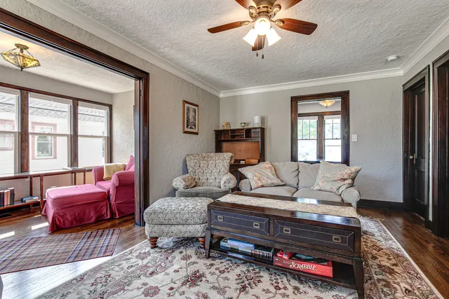 a living room with furniture a flat screen tv and a large window