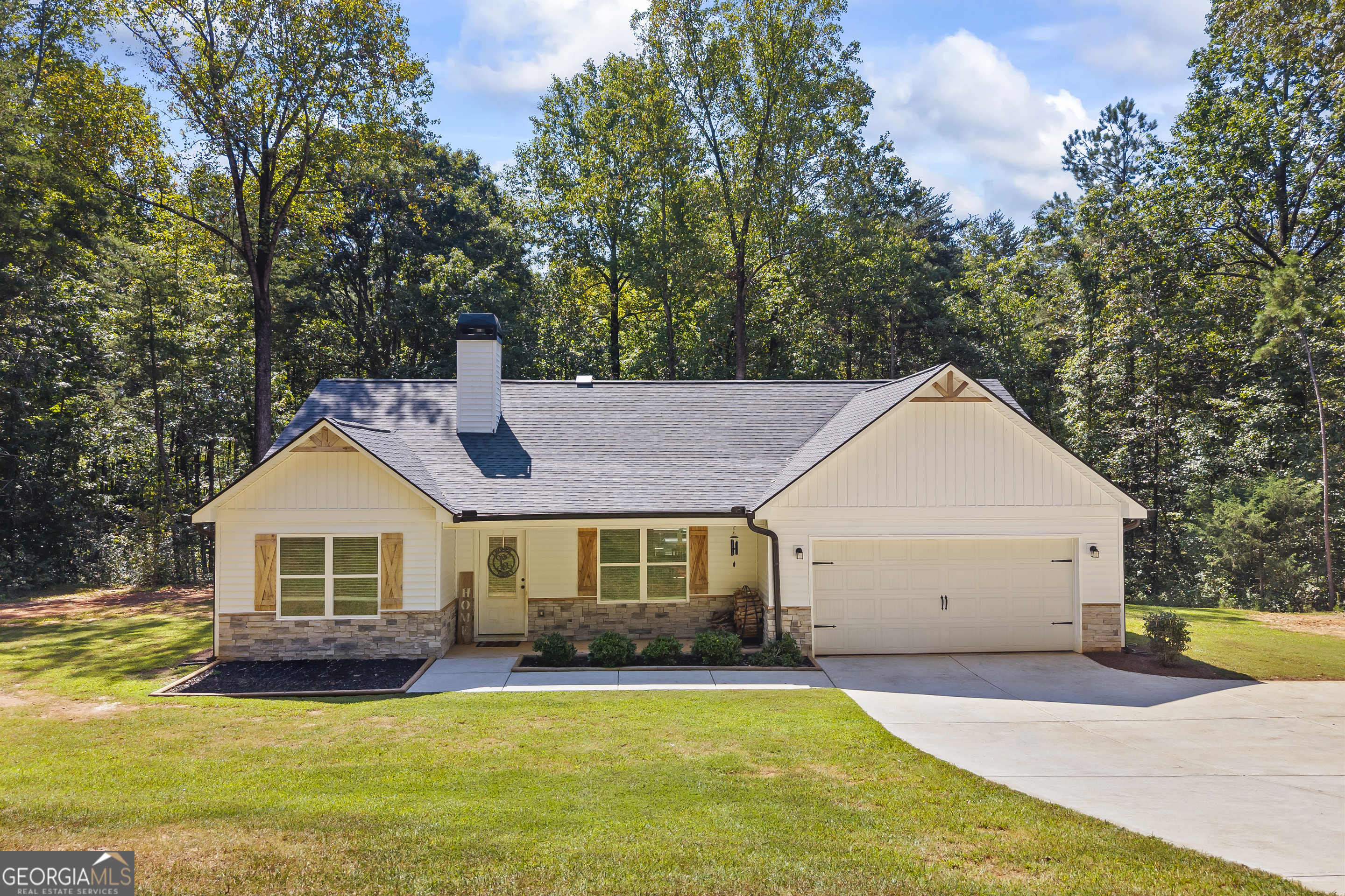 a front view of a house with a yard and porch