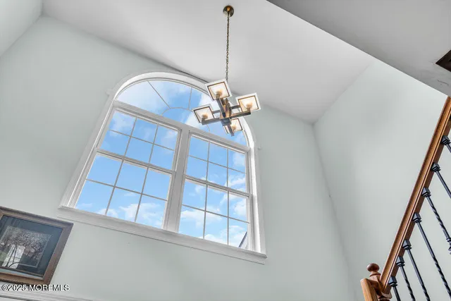 a kitchen with stainless steel appliances granite countertop a refrigerator microwave and wooden floor