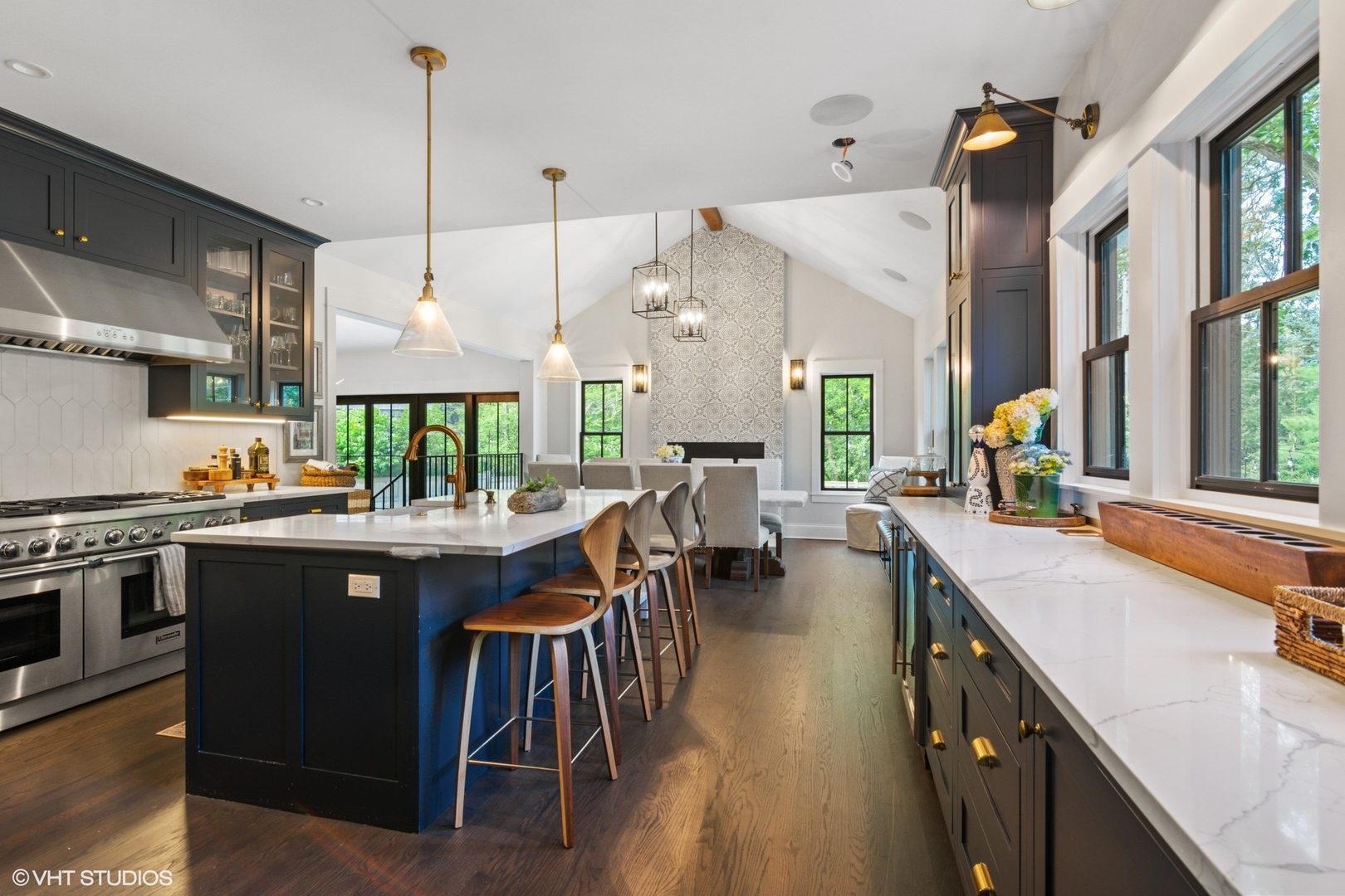 735 Baldwin Road Highland Park, IL 60035 - Photo 5 of 30 a kitchen with stainless steel appliances granite countertop a stove a sink dishwasher and a dining table with white cabinets