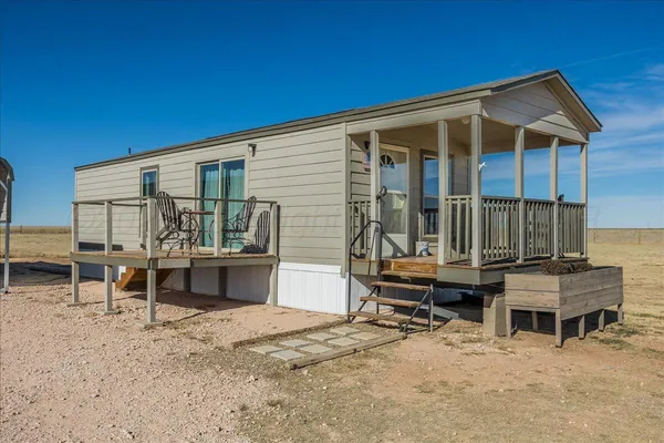 a view of a house with backyard porch and sitting area
