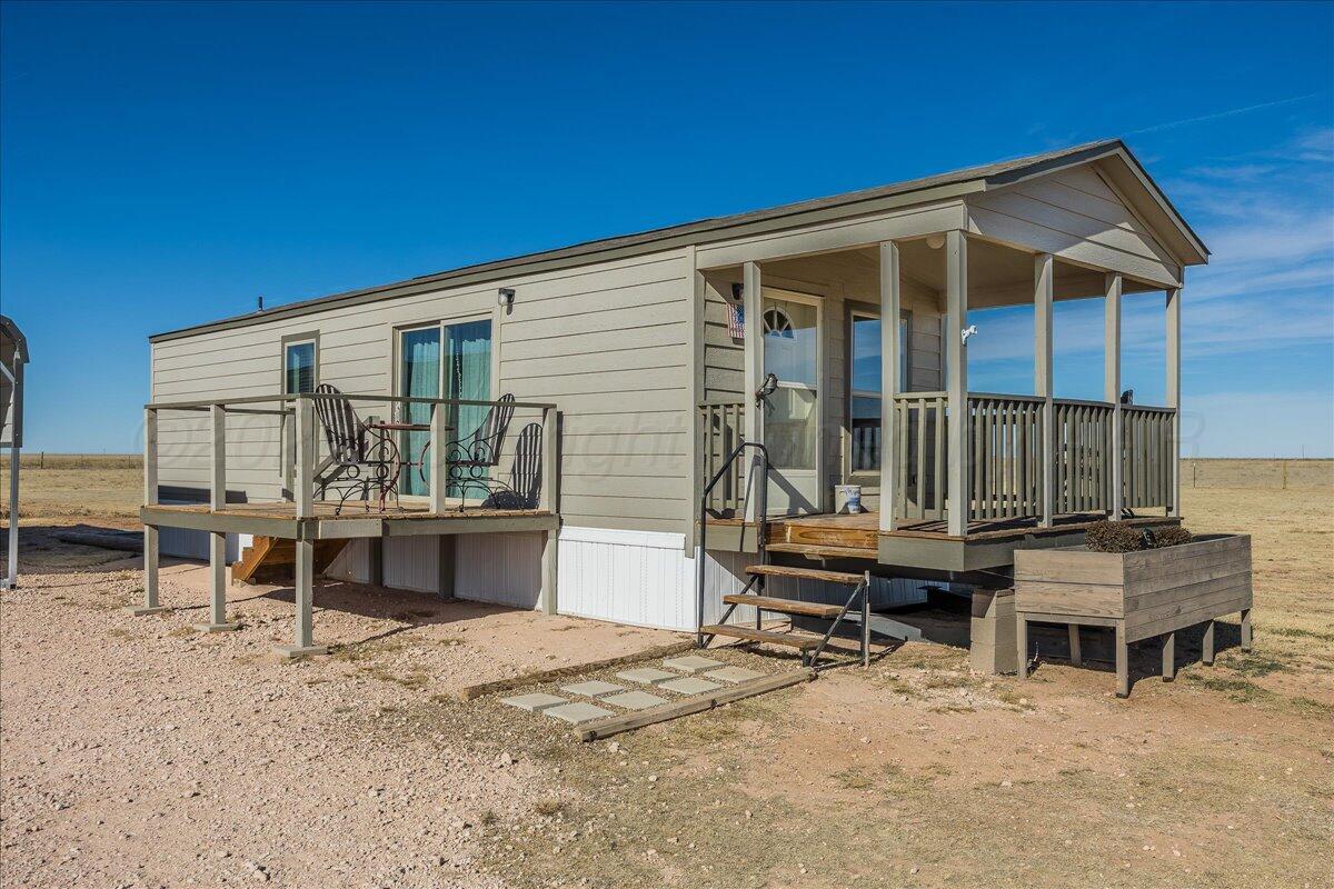a view of a house with backyard porch and sitting area