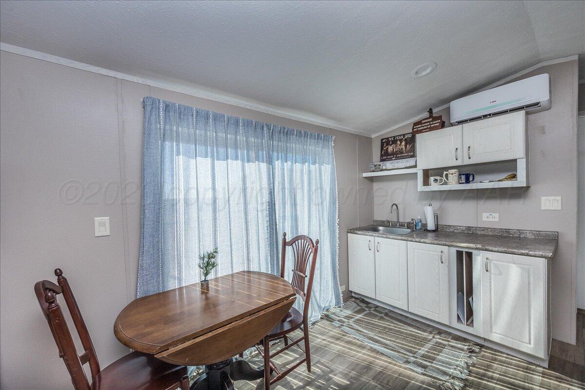 39600 Farm To Market 1705 Happy, TX 79042 - Photo 5 of 10 a kitchen with stainless steel appliances granite countertop a stove top oven a sink a dining table and chairs