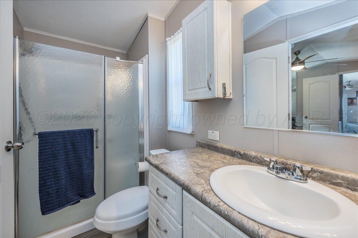 39600 Farm To Market 1705 Happy, TX 79042 - Photo 6 of 10 a bathroom with a granite countertop sink a toilet a mirror and shower