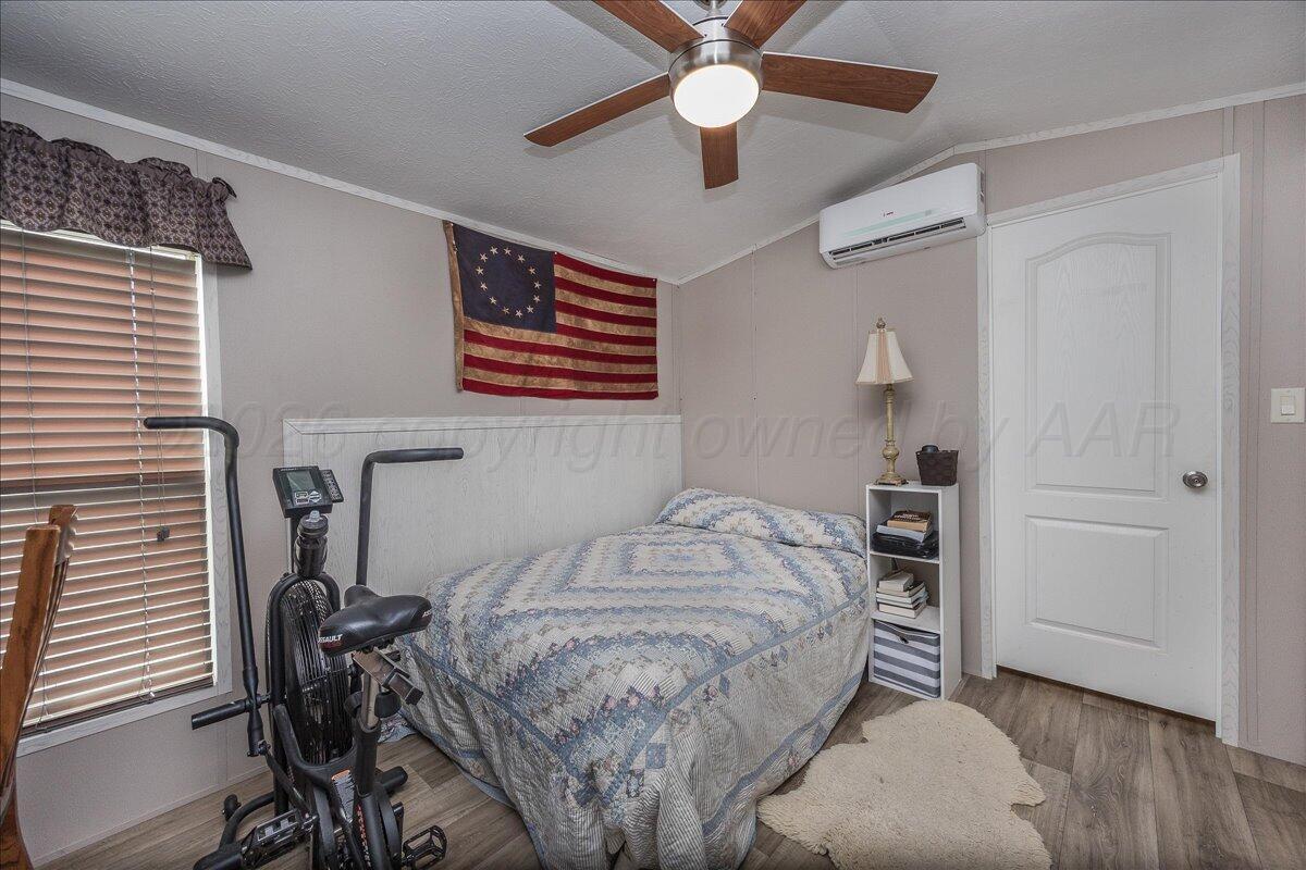 39600 Farm To Market 1705 Happy, TX 79042 - Photo 8 of 10 a bedroom with a bed and a chandelier