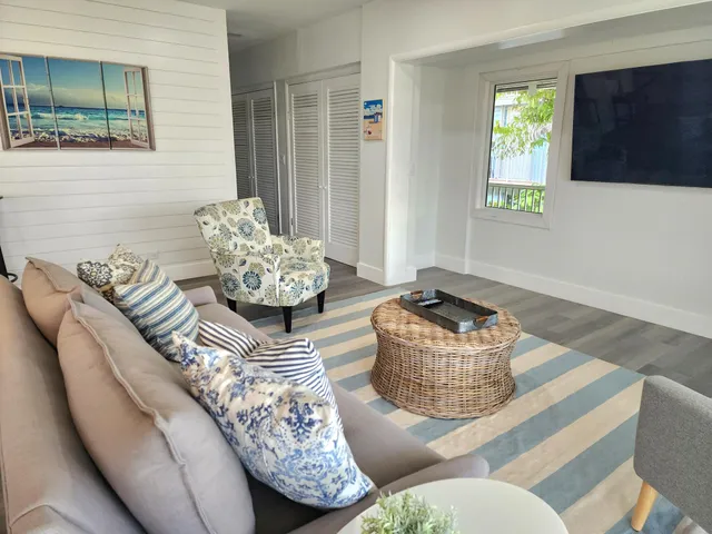 a room with pool table and windows
